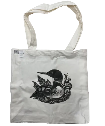 Tote bag with a black and white bird design on a light gray background