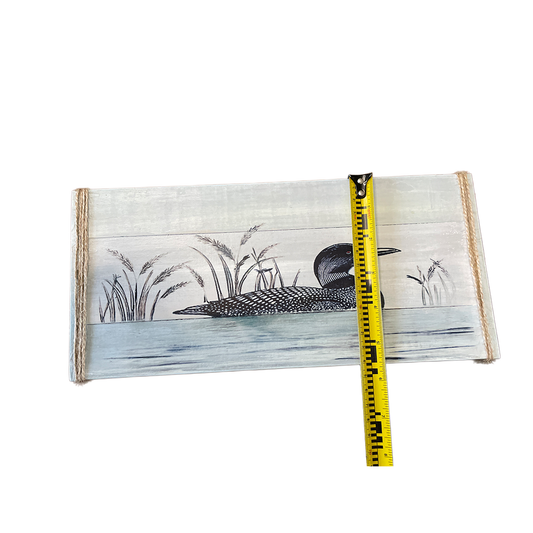 Wooden panel with a painted duck and reeds design, accompanied by a measuring tape for scale.