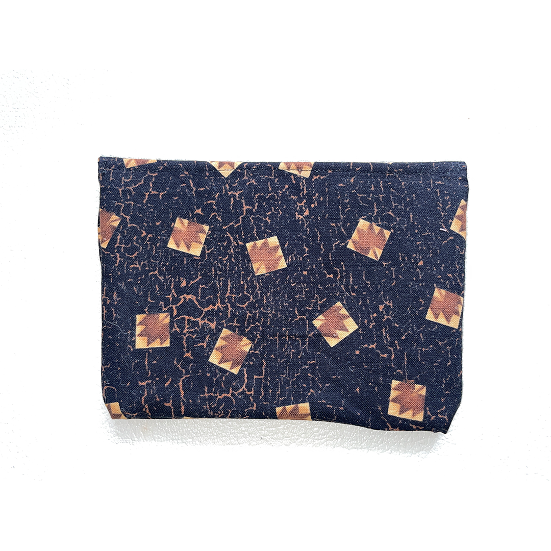 pouch with gold square pattern on a white background